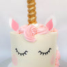 Pink and white unicorn cake with buttercream frosting
